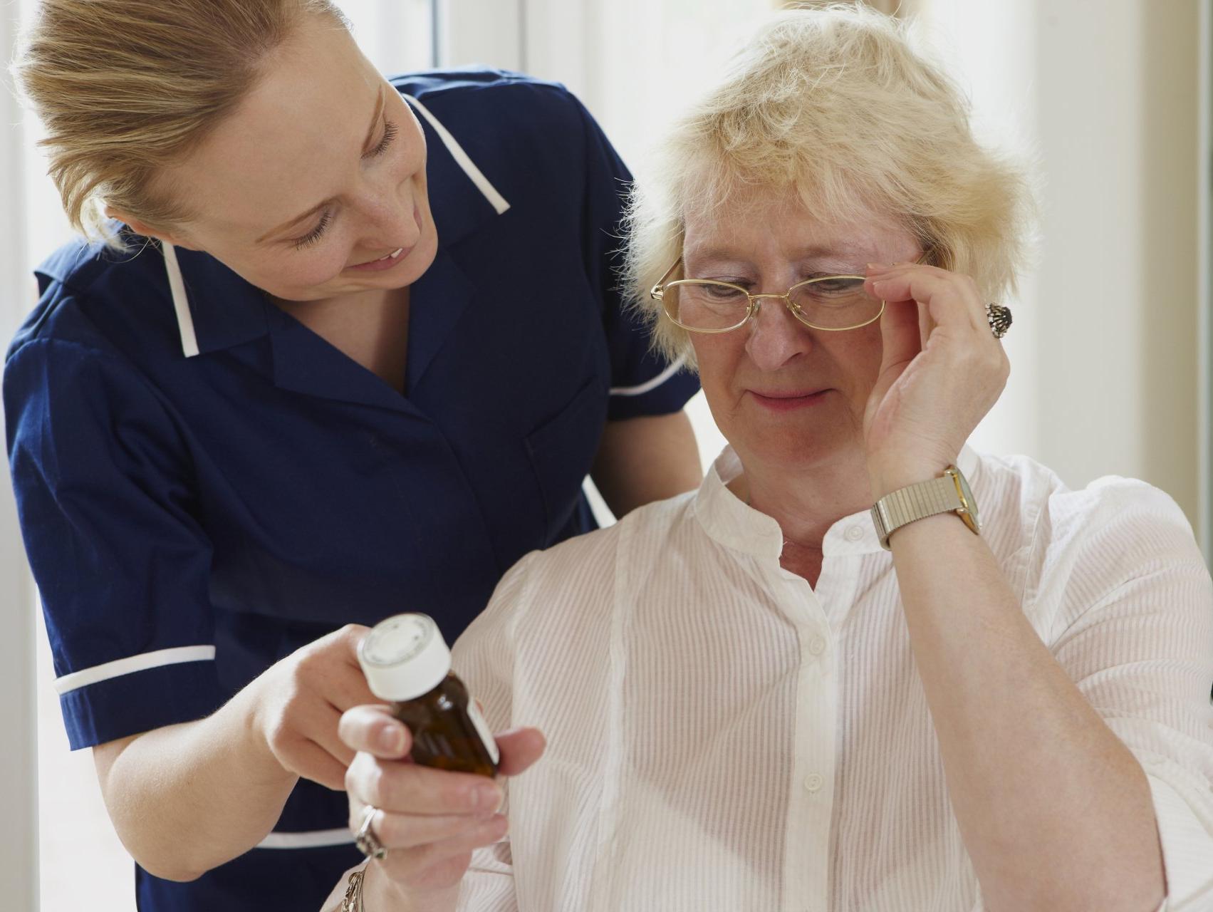 Carer helps person with medication