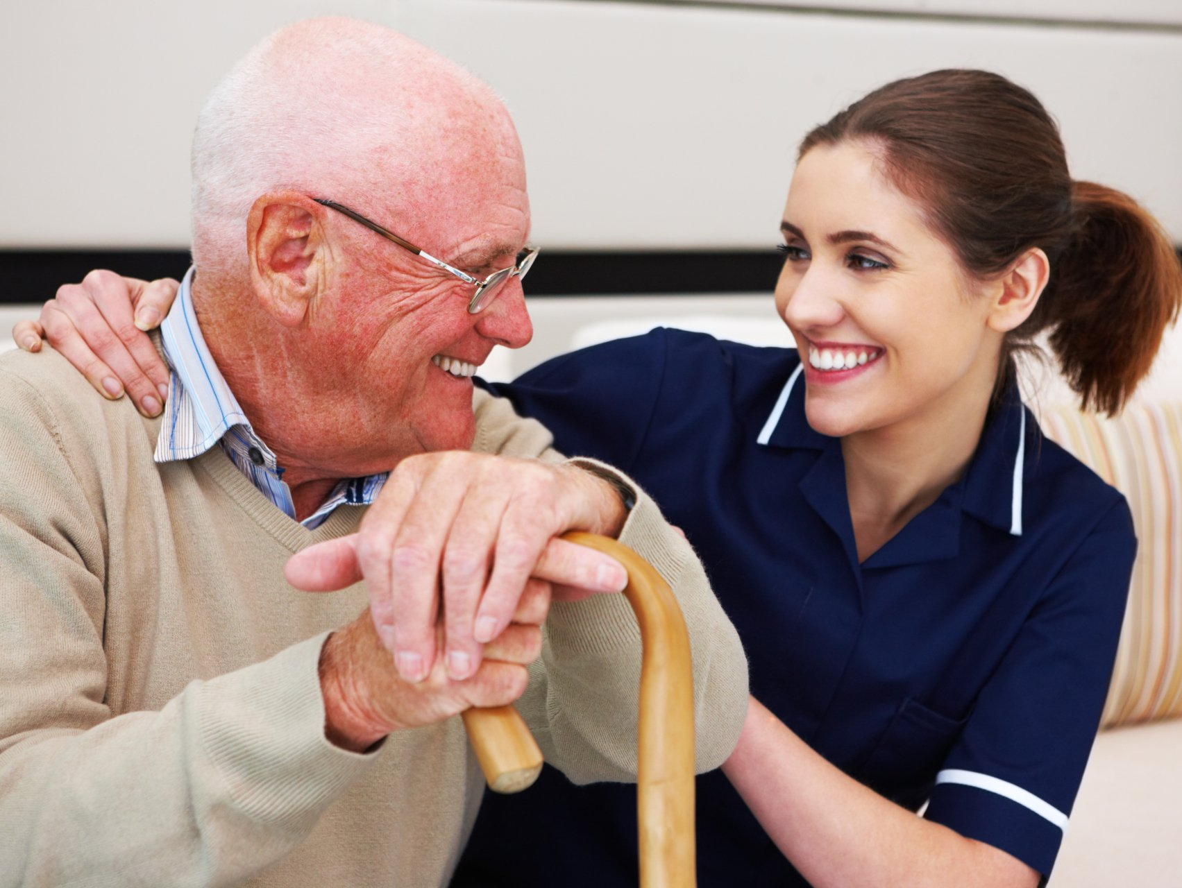 Carer and a person smiling at one another