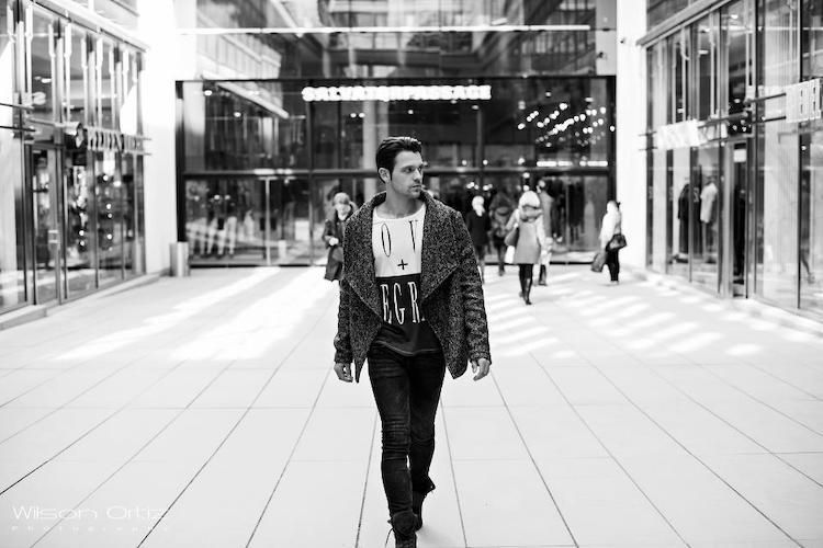 Schwarz Weiß Foto, Mann läuft in der Stadt und blickt sich um.