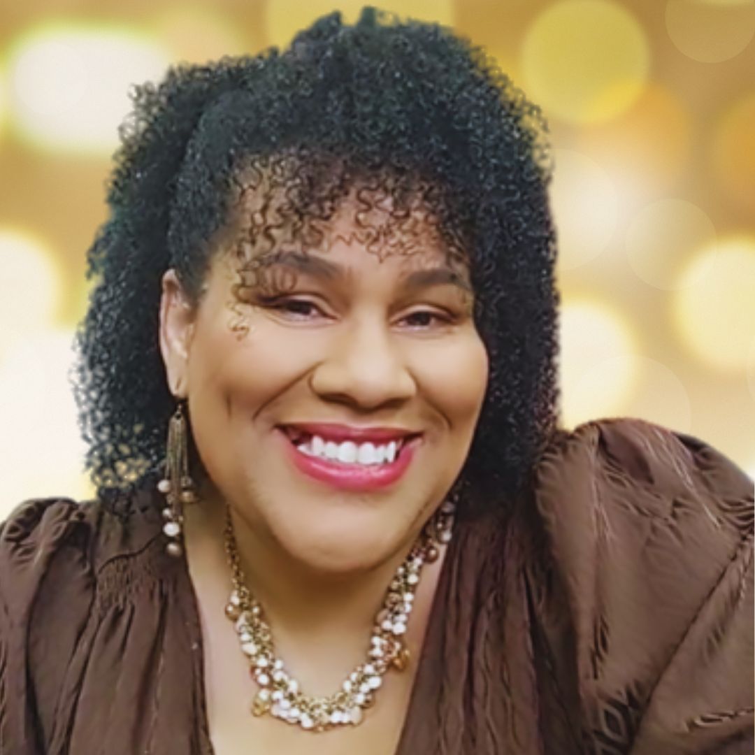 Fatima Bey smiling in a brown blouse against a warm gold bokeh background, square crop.