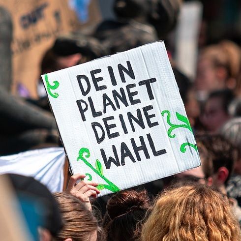 Auf fingreen.de grün und nachhaltig investieren. Das Bild zeigt ein Plakat für den Klimaschutz.