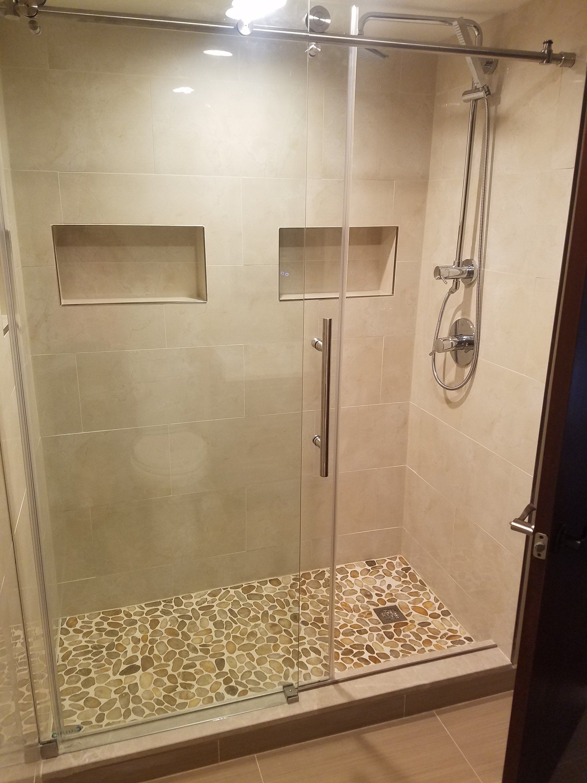 bathroom renovation in Elkins Park two shower niches pebble floor rain shower head