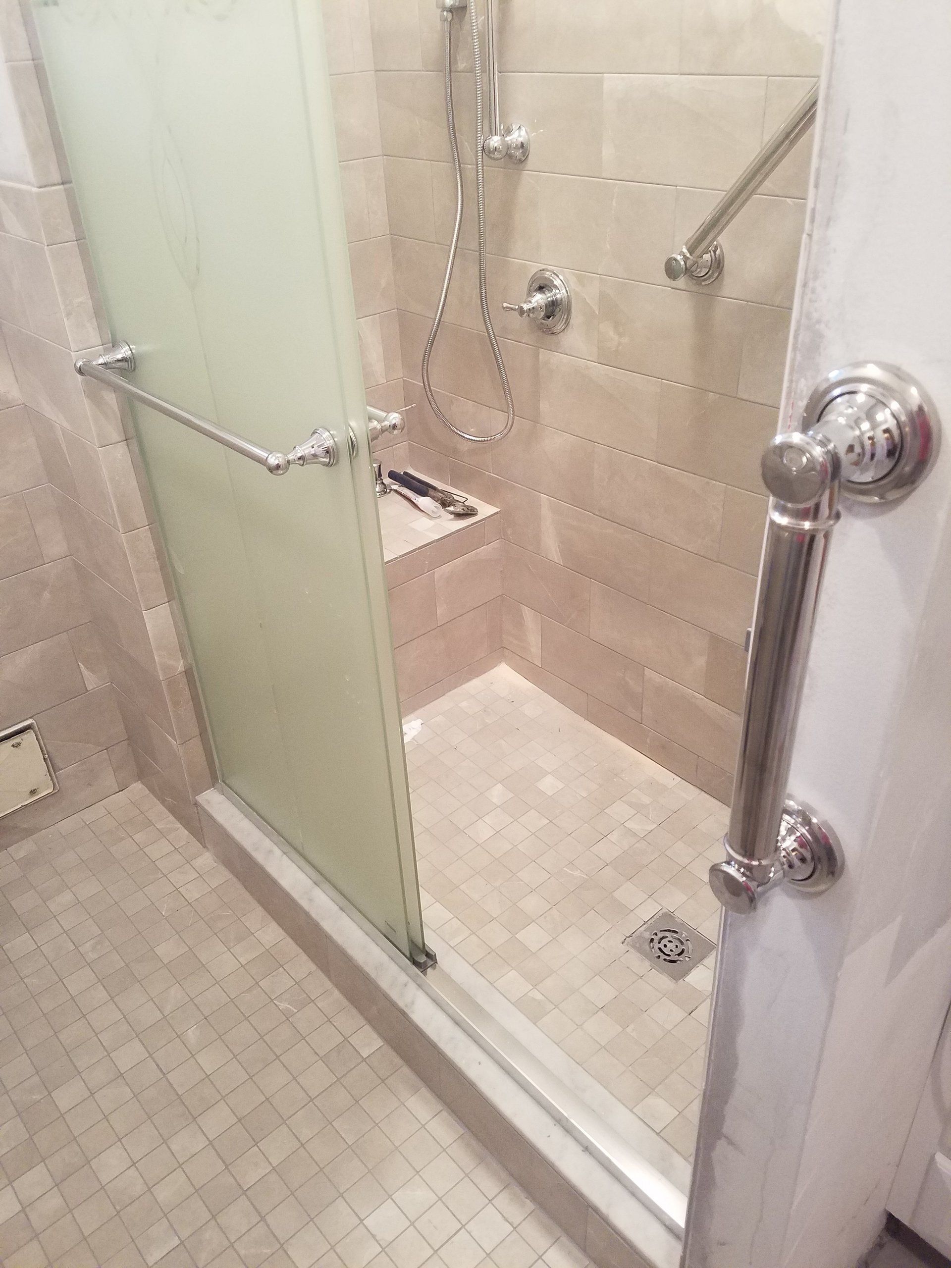 senior bathroom remodel in Philadelphia bathtub to shower conversion with custom shower grab bars shower bench and dual shower head