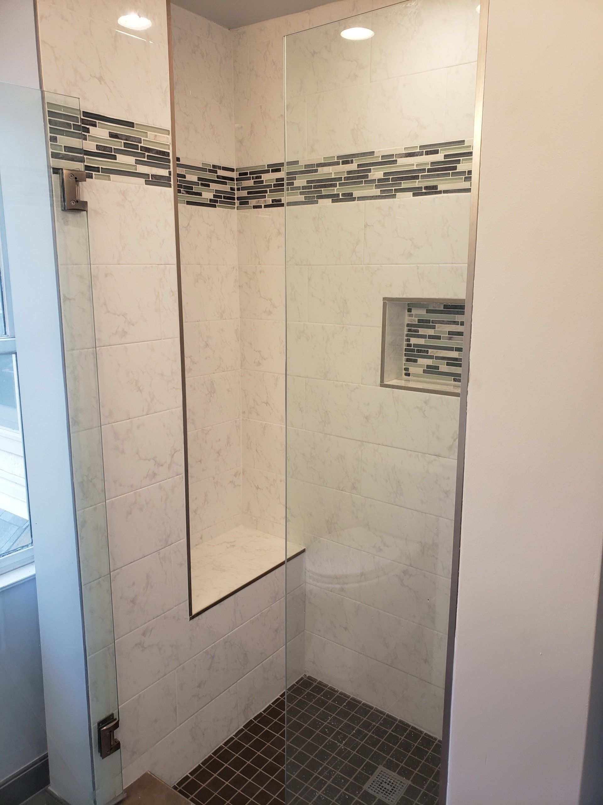 tile work in shower stall with bench and shower niche in Elkins Park bathroom remodel
