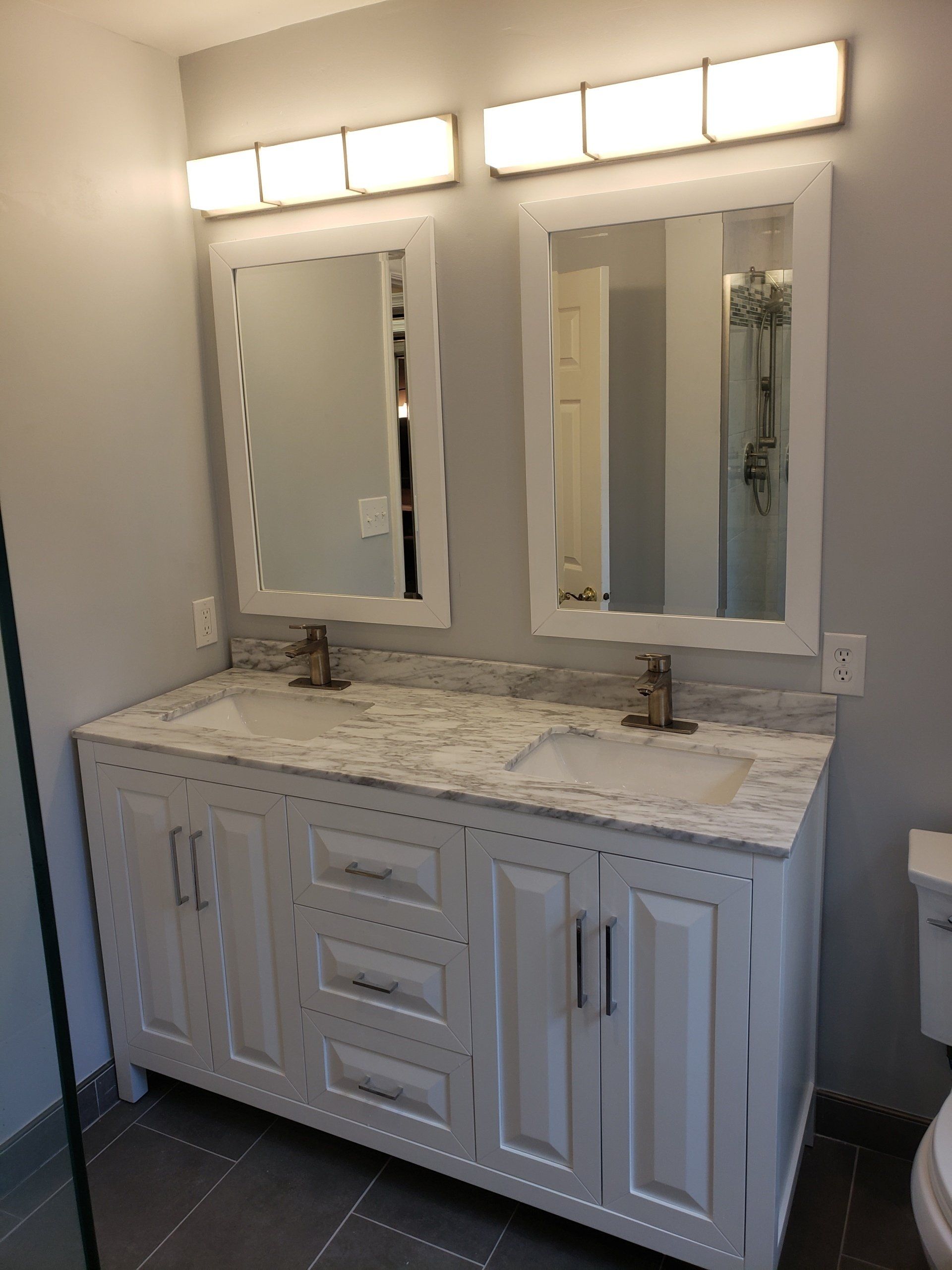 Double sink and double mirror vanity with modern design and marble top in Elkins park bathroom remodel