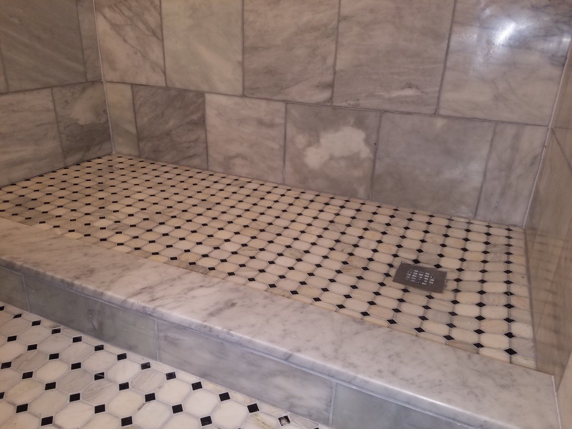 close up marble and tile combination in shower remodel in Jenkintown