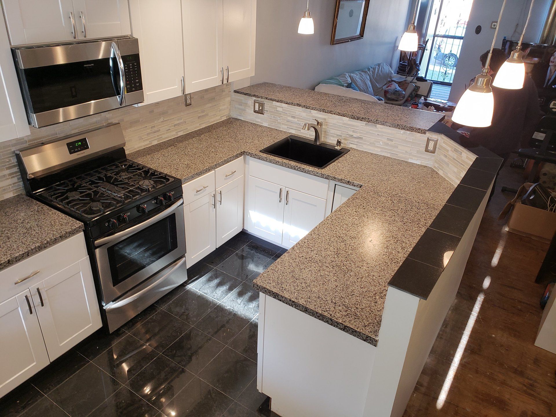 granite countertops, backsplash, breakfast bar and floor tile in cheltenham kitchen remodel
