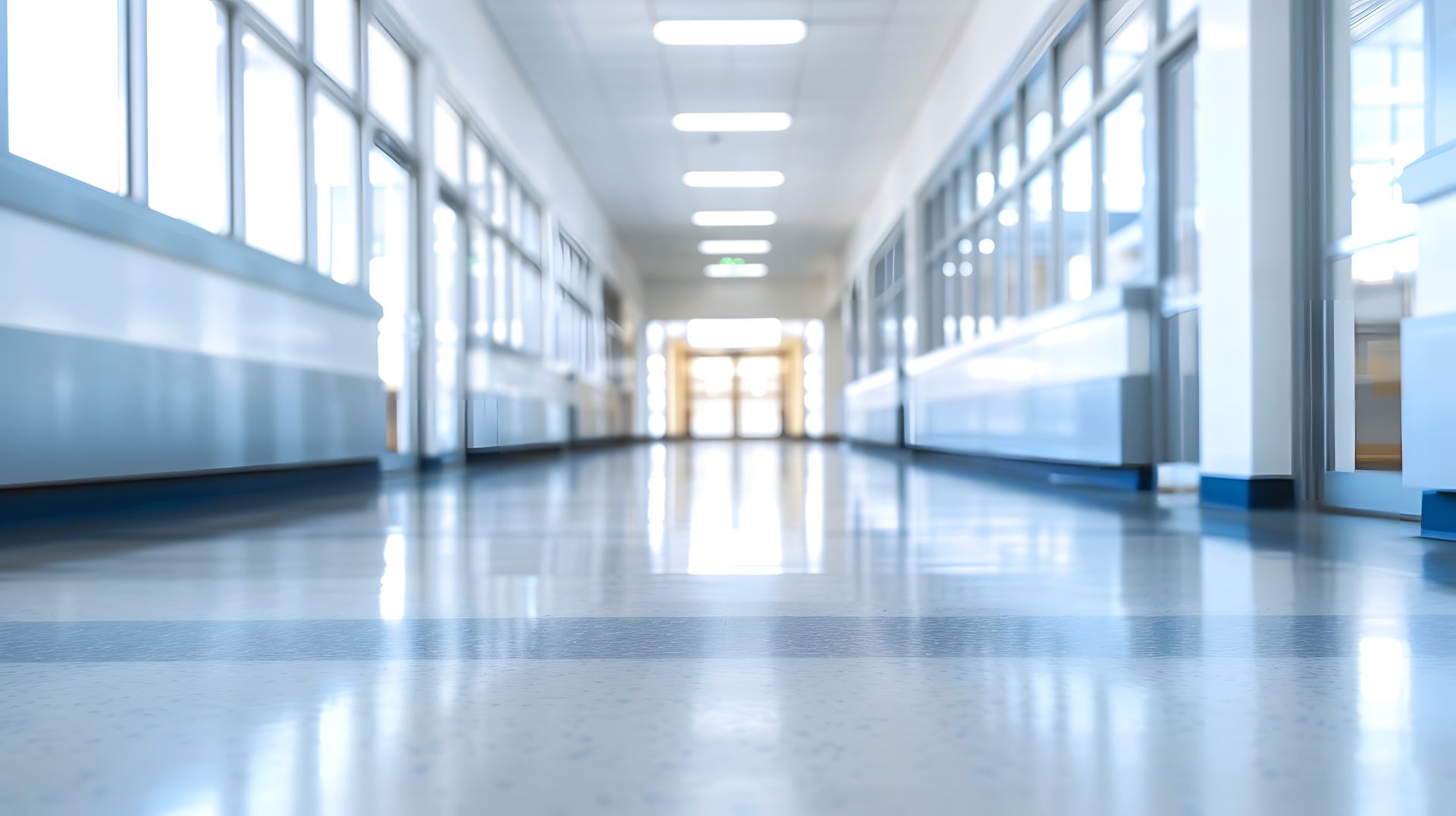 School corridor opening toward light, representing a fresh start after PFI expiry.