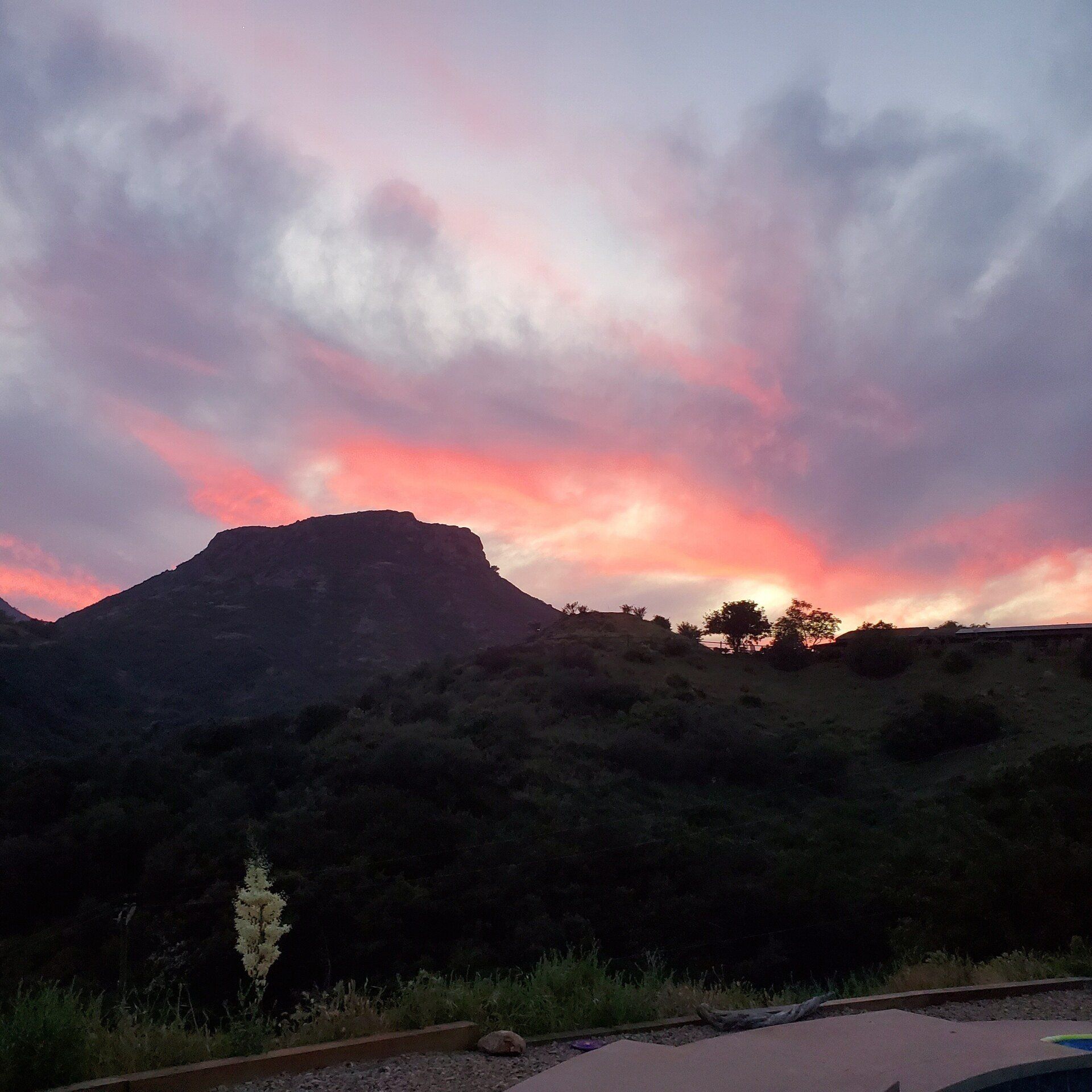 Red sunset with mountains in the background; view from brick area at sunset