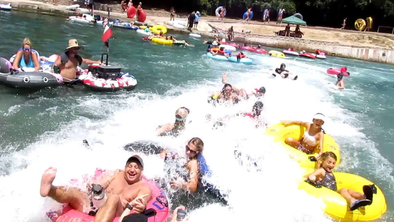 Fun group splashing out of the New Braunfels Tube Chute - Texas Tubes