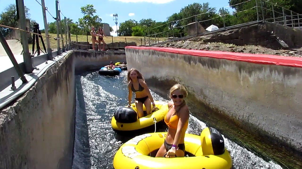Girls having fun tubing through the New Braunfels Tube Chute - Texas Tubes