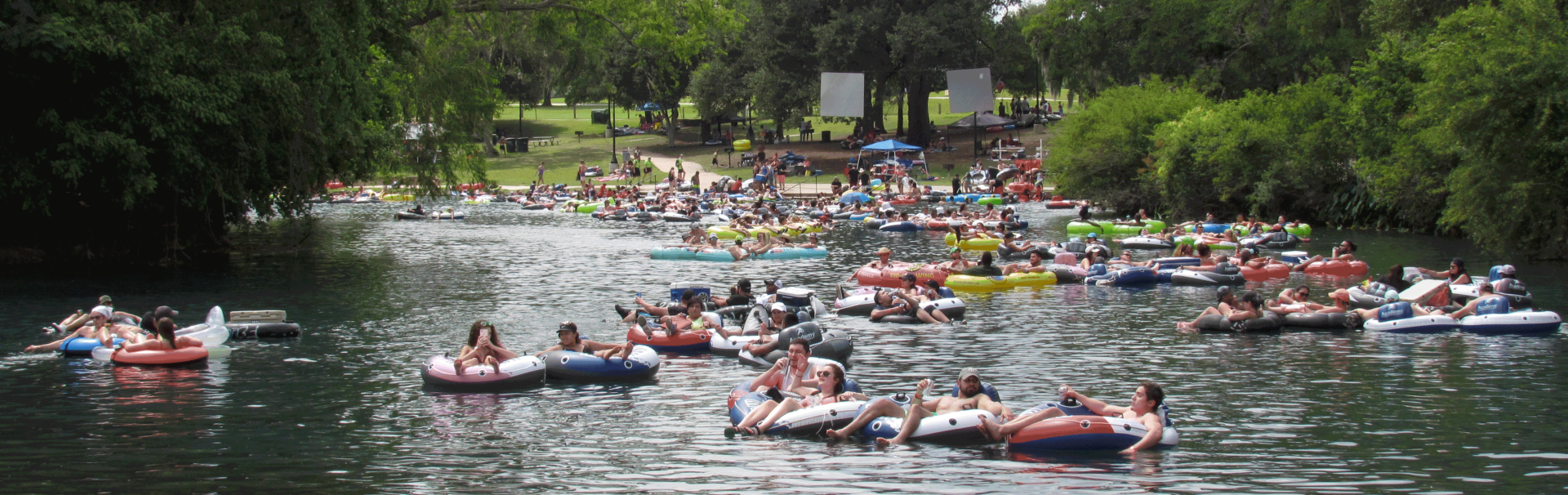 Lots of People Tubing on the Comal River near Texas Tubes and Hinman Island Park adhering to the Comal River Rules in New Braunfels, TX Lots of People Tubing on the Comal River near Texas Tubes and Hinman Island Park adhering to the Comal River Rules in New Braunfels, TX