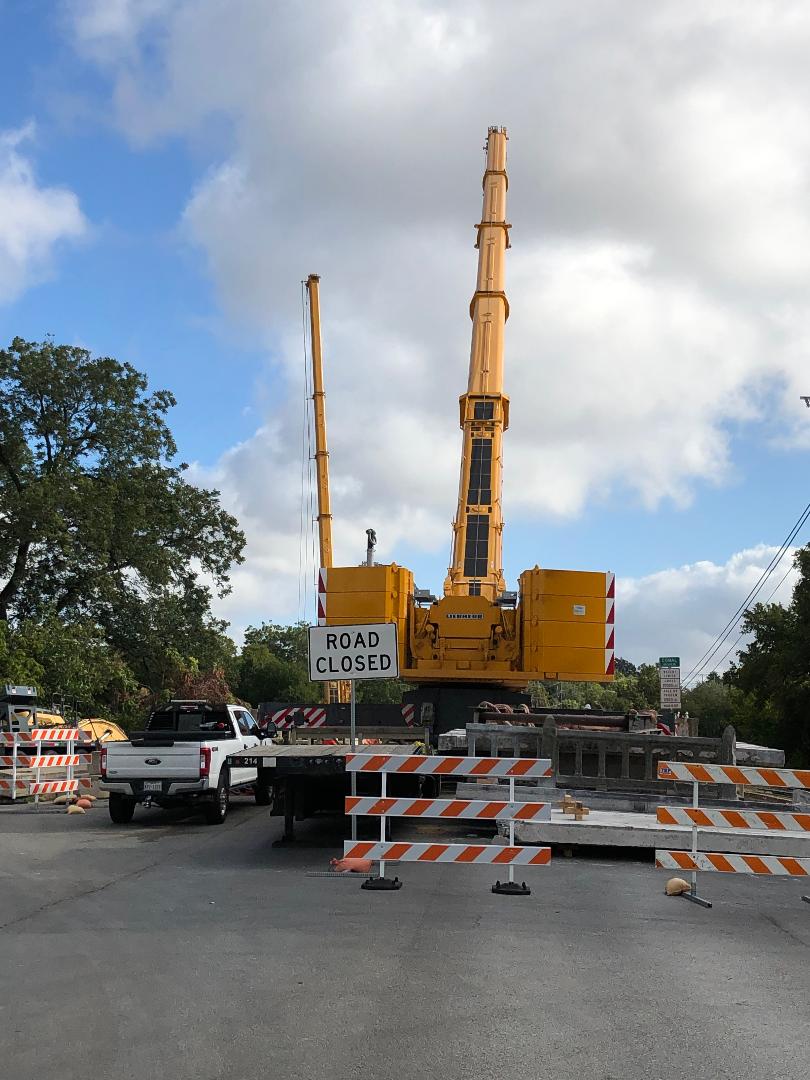 A huge Crane is in place to remove the old narrow top deck of the San Antonio Street Bridge in New Braunfels and to install the new top deck, which will be much wider to accomodate emergency vehicles and other large vehicles safely - Texas Tubes  on the Comal River - New Braunfels, TX