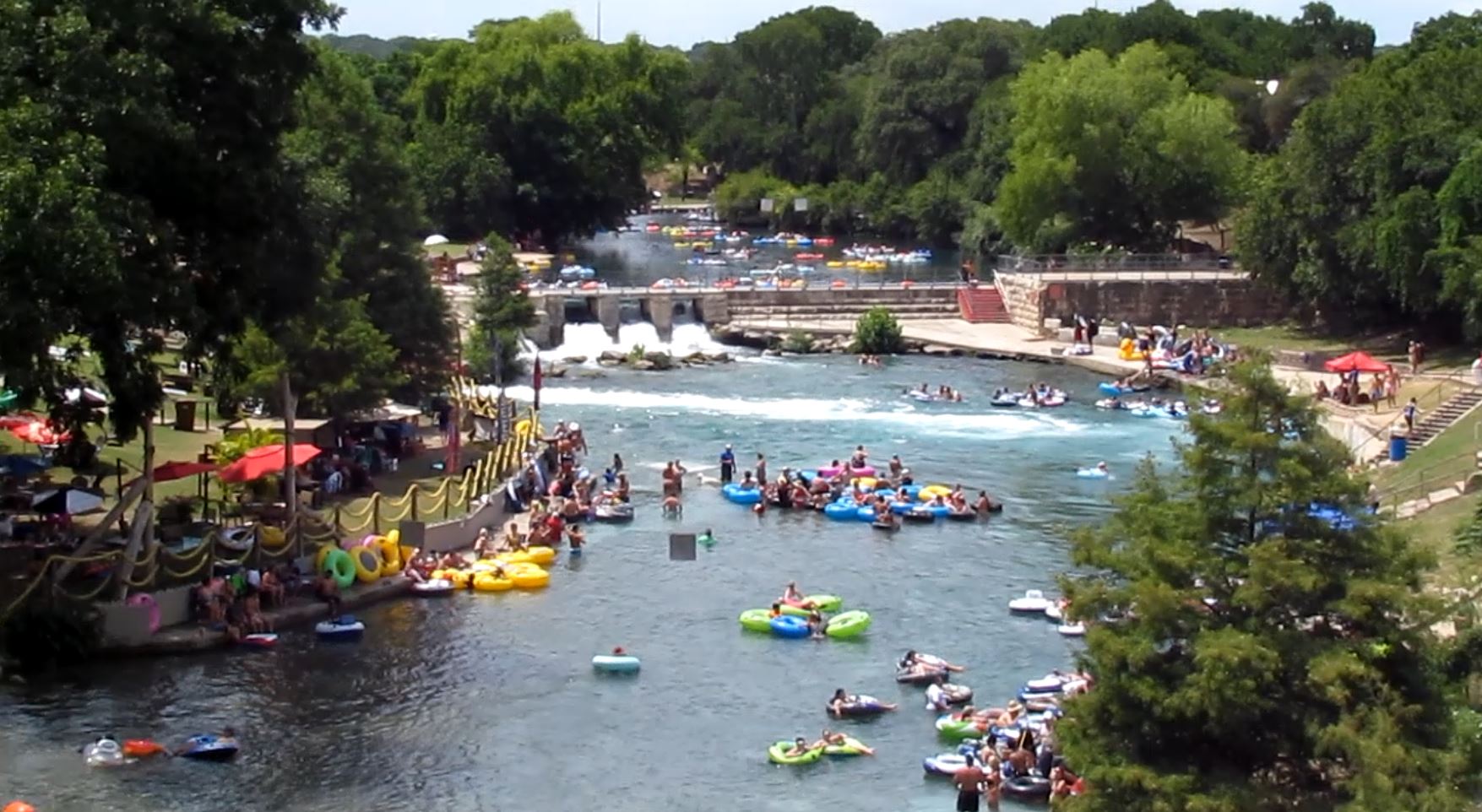 View of Clemens Dam and the New Braunfels Tube Chute on the Comal River from the San Antonio Street Bridge with Texas Tubes