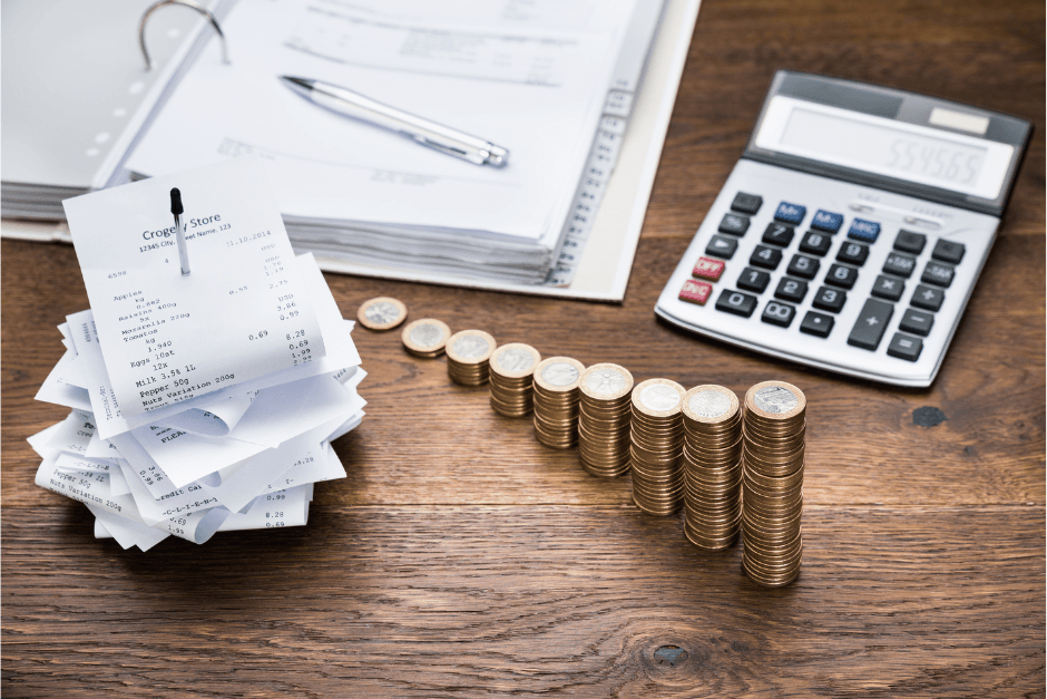 Bookkeeping, receipts, calculator and coins on desk