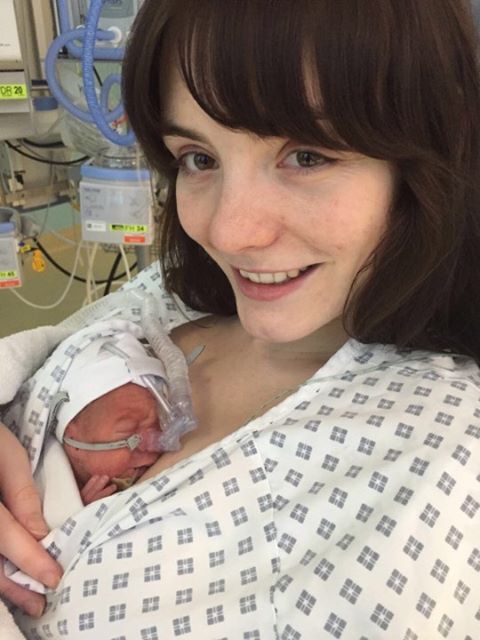 Aimee holding her premature son James in the NICU