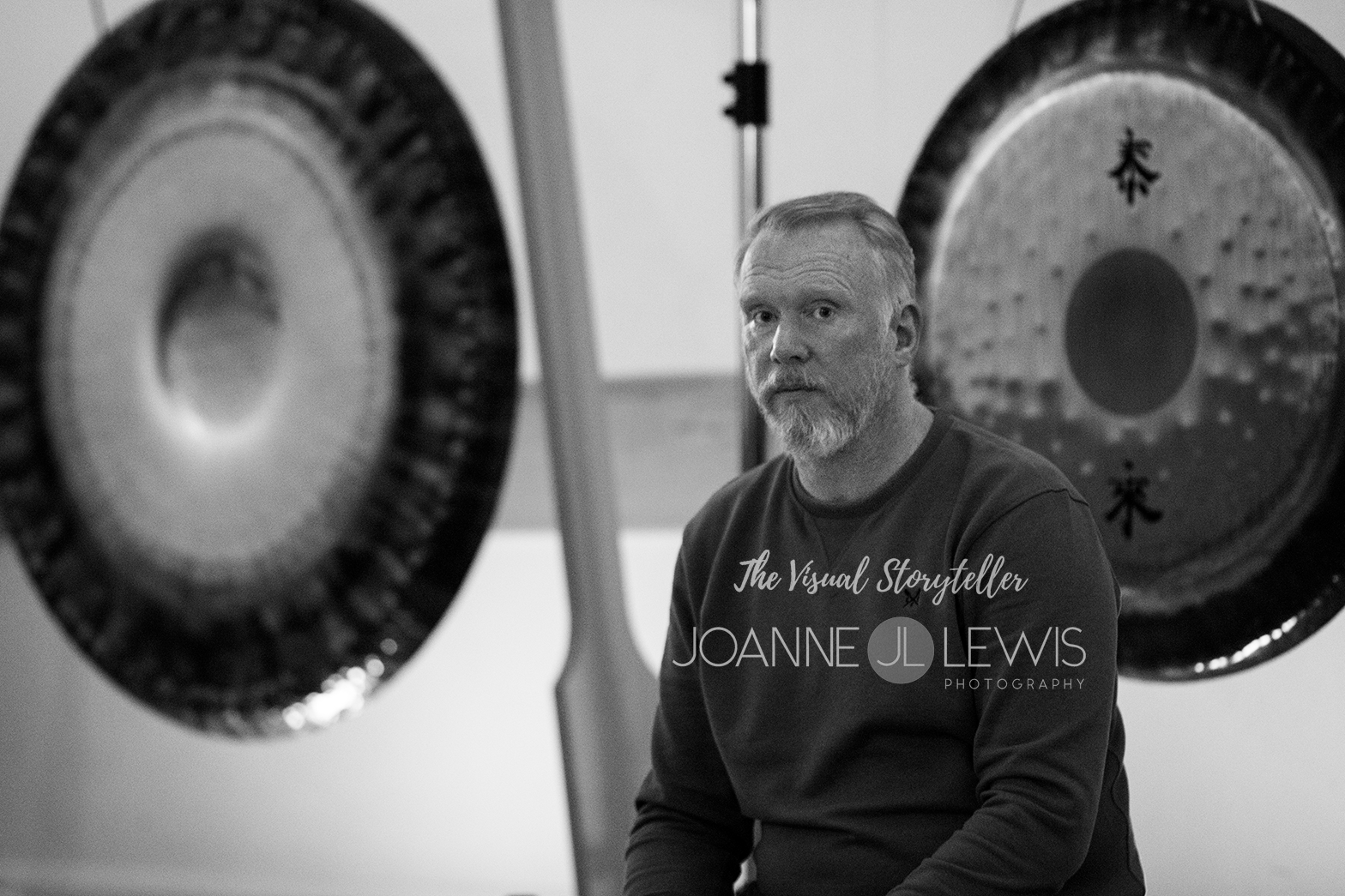 Thai Chi Quigong and Gong player monochrome photo with gongs