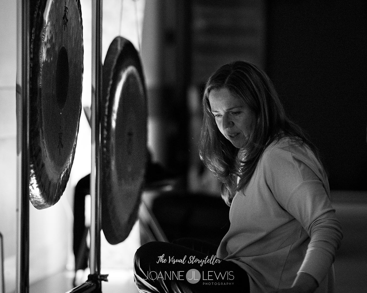 Lady playing Gong's for gong bath Monochrome
