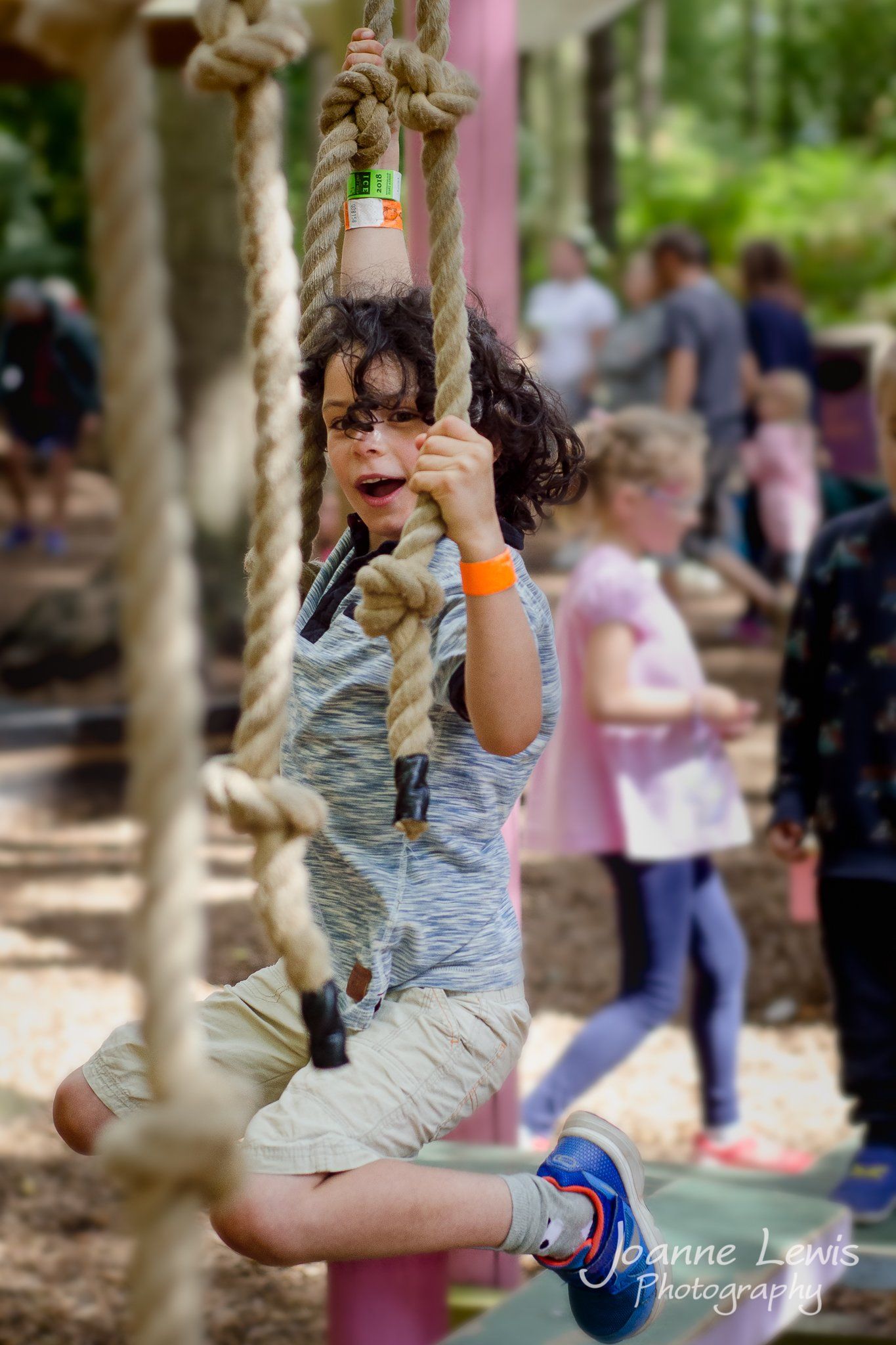 Boy swinging on ropes at Bewilderwood