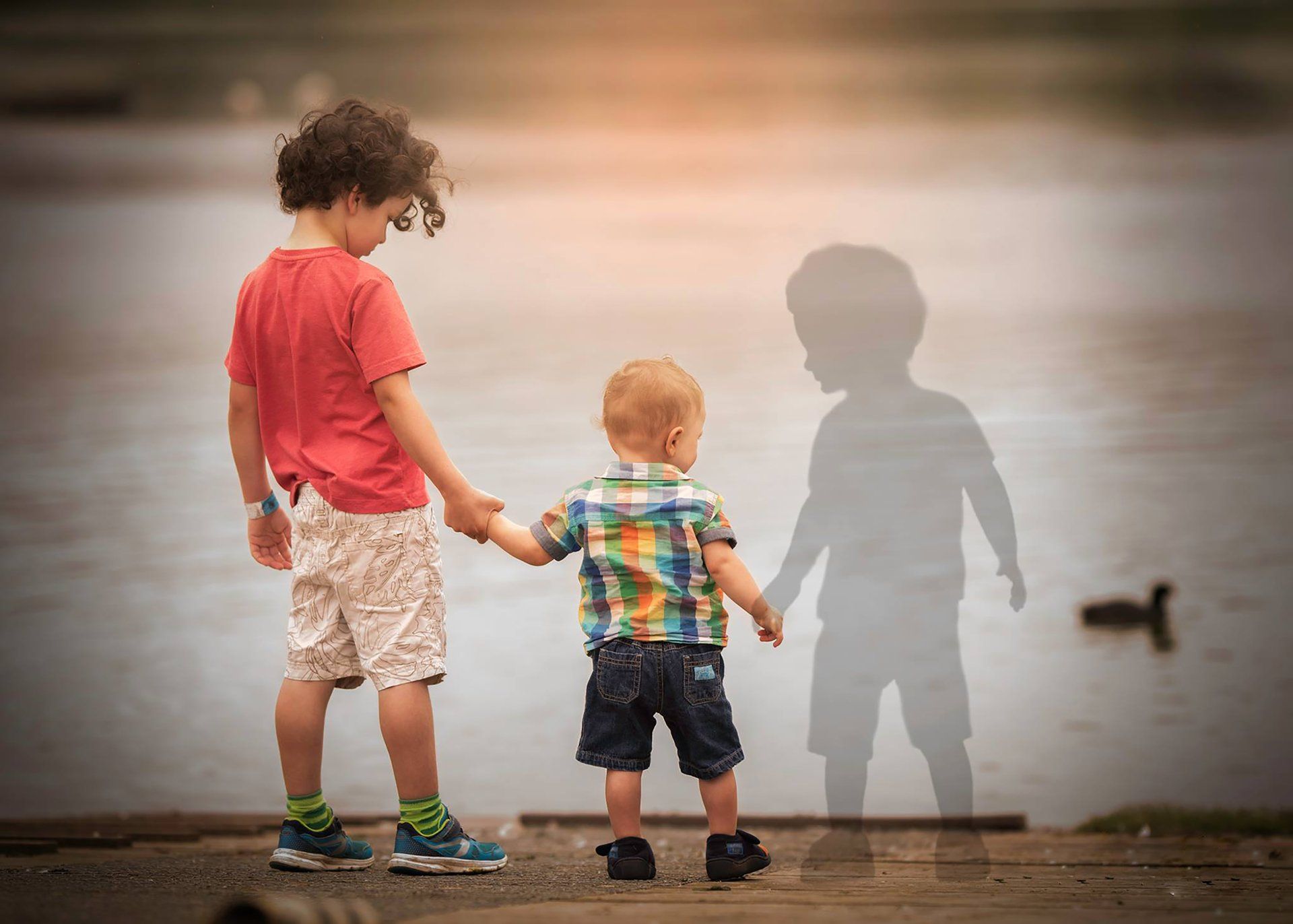 brothers holding the shadow hand of their brother who died