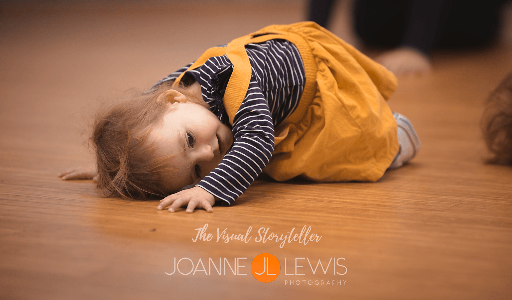 little girls laying on floor in pretty yellow dress