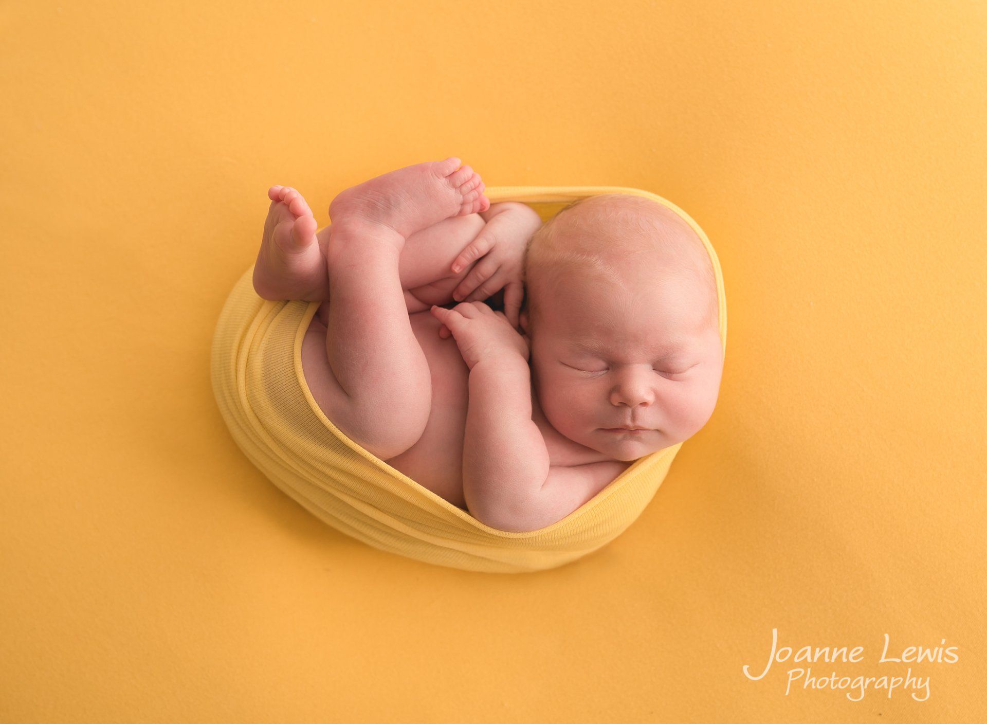 Newborn Baby photographed by Joanne Lewis Photography in yellow