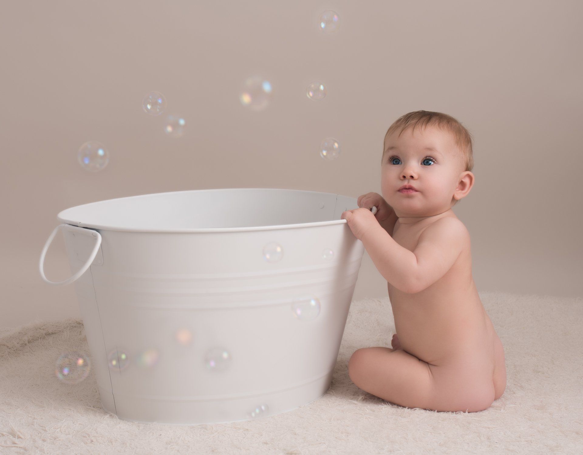 Toddler in Hertford Studio watching bubbles for sitter photo session