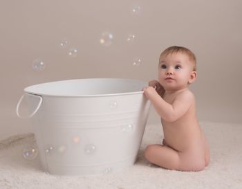Toddler with bubbles bath in Hertford studio photoshoot