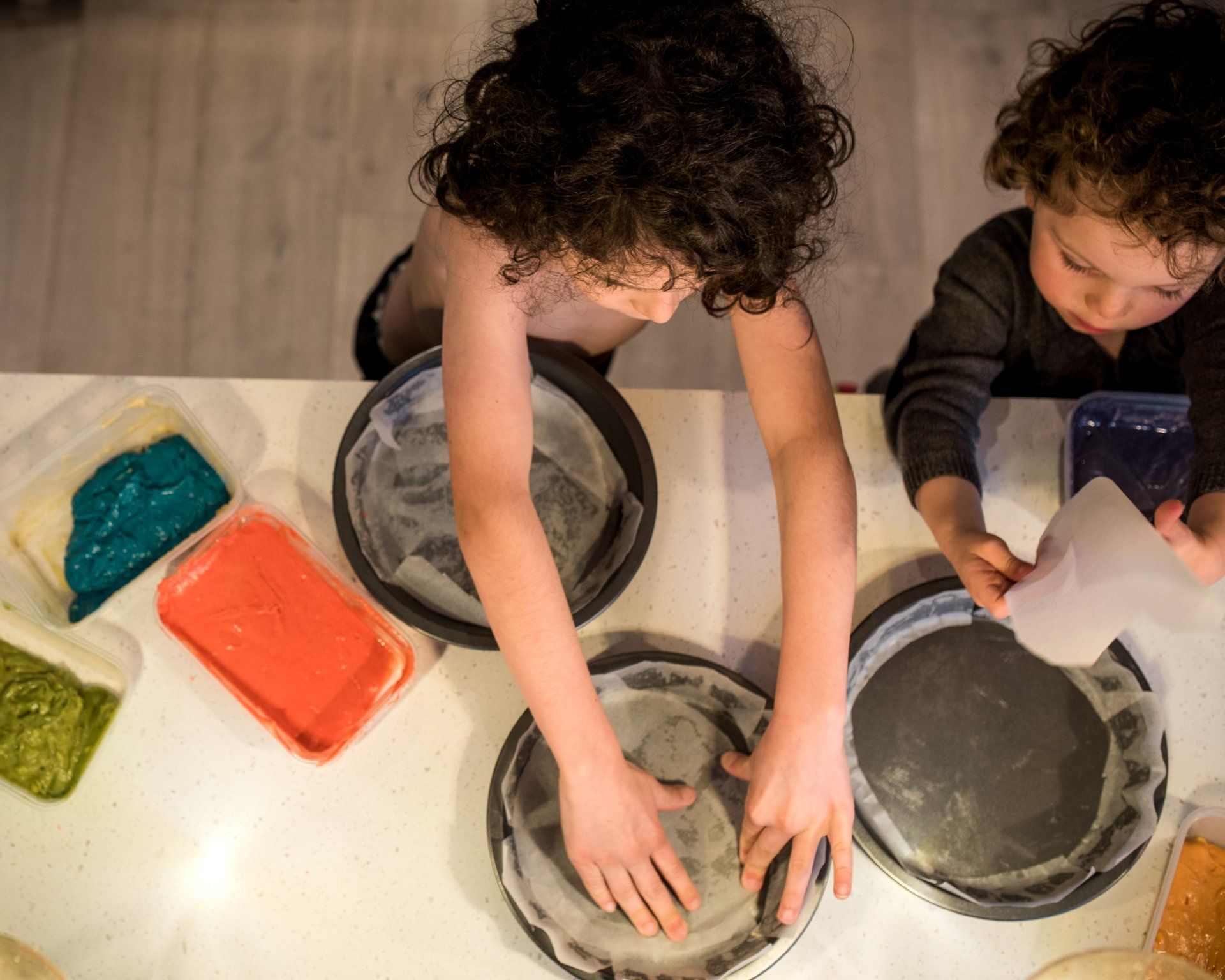 Boys lining cake tins
