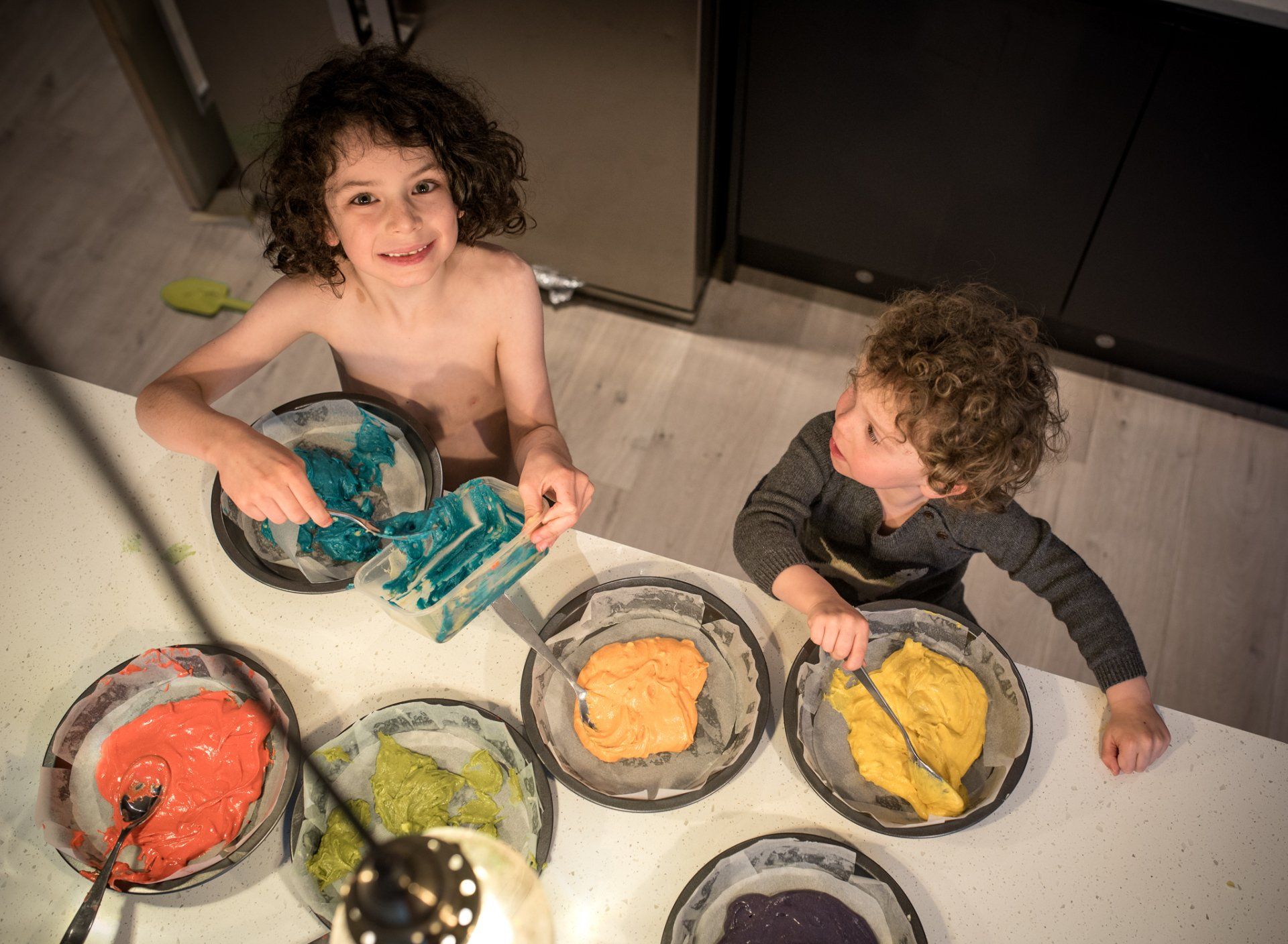 Boys baking a rainbow cake