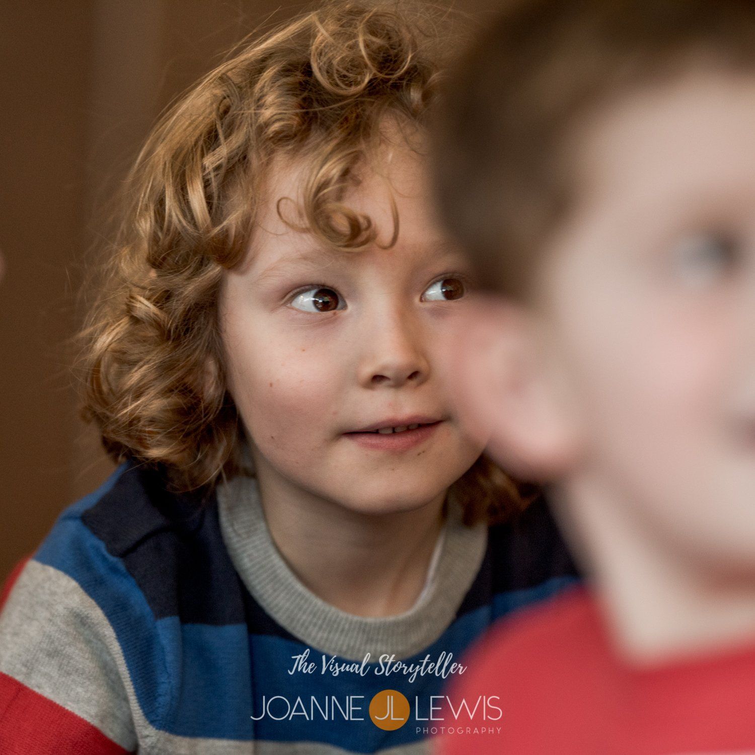 Boy with beautiful curls being photographed at Hertford birthday party
