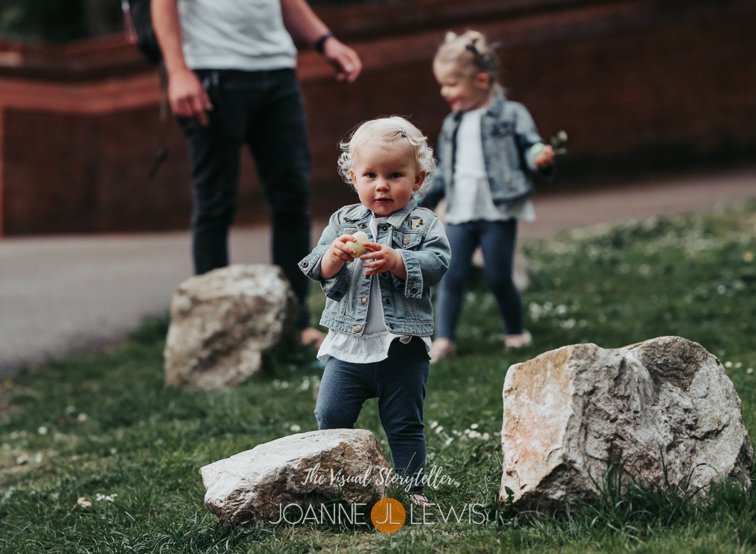 Little girl finding an Easter egg on walk during social distancing