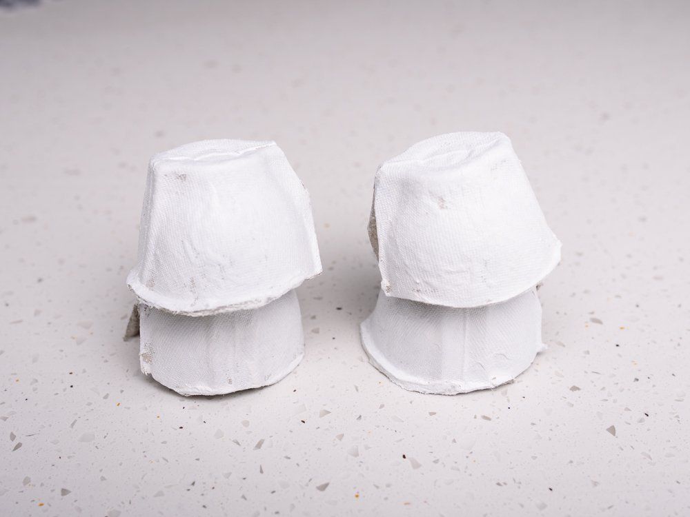 White egg cups stacked to make halloween ghost crafts