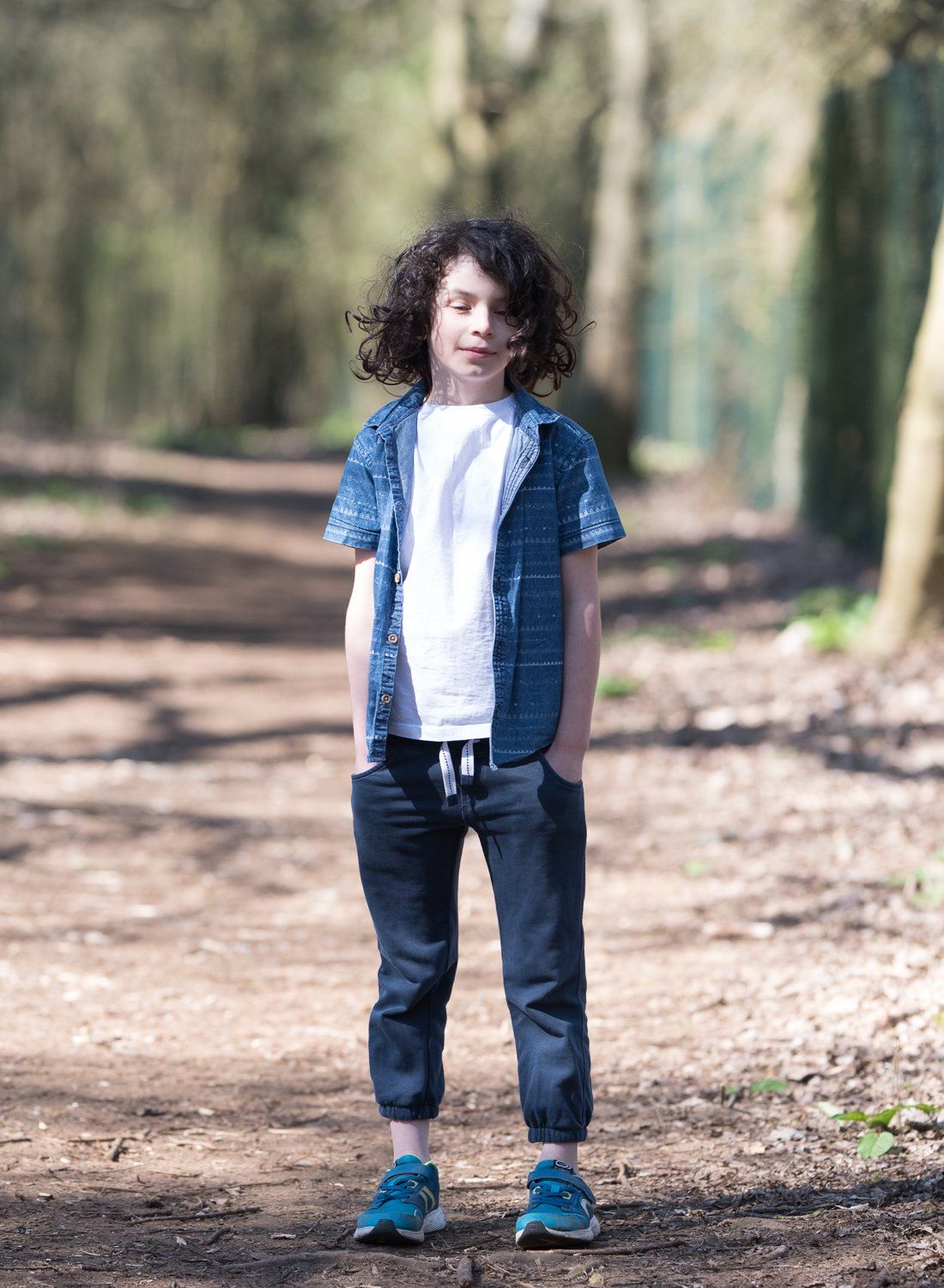 Standing in the forest in bright hard sunlight