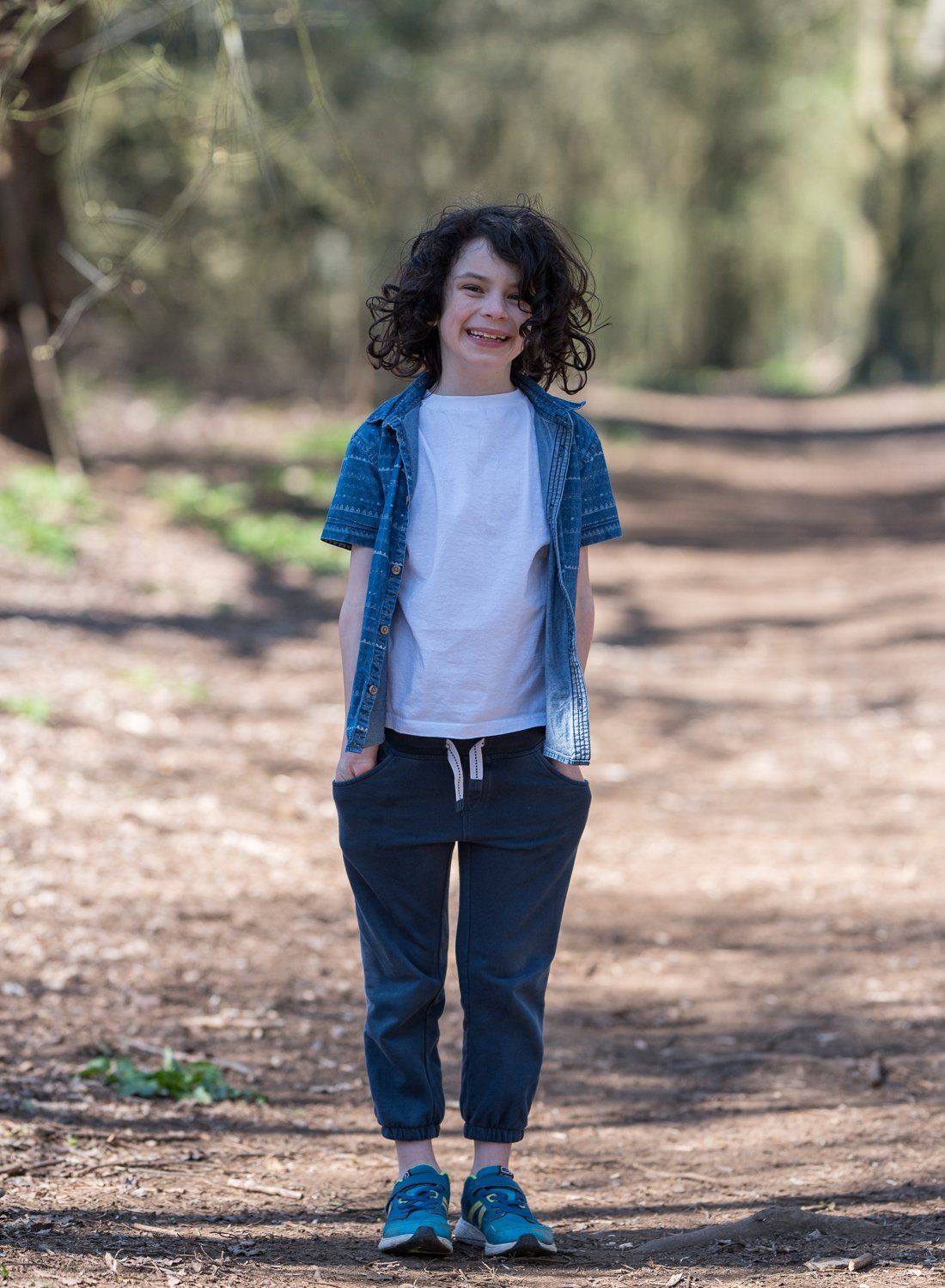 Standing in the forest on a bright day in soft sunlight from shadows