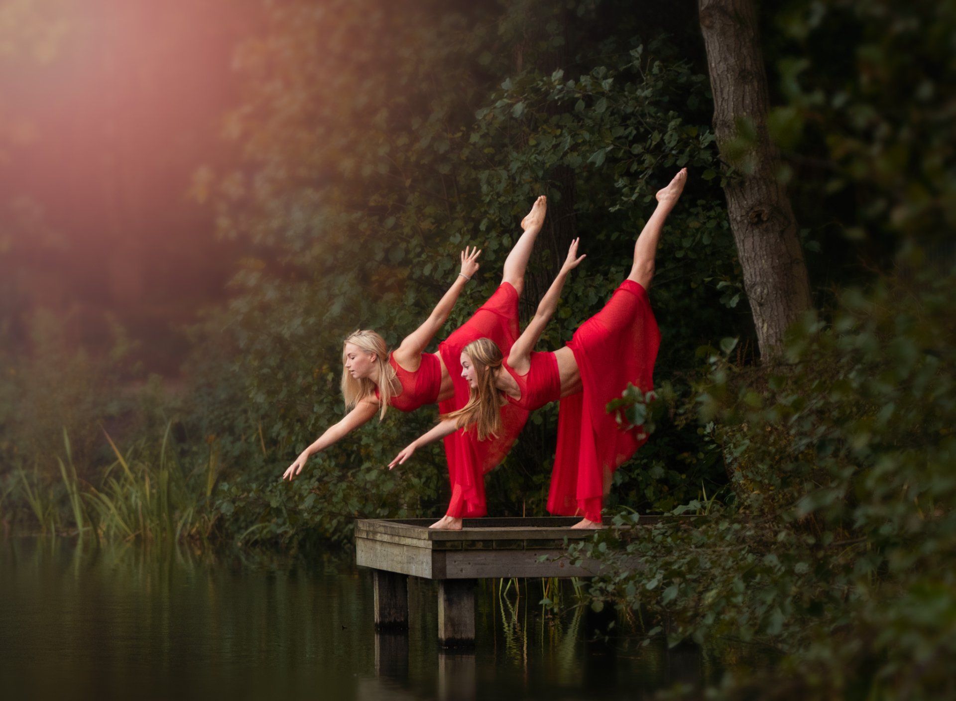 Two dancers dressed in bright red during outdoor photoshoot