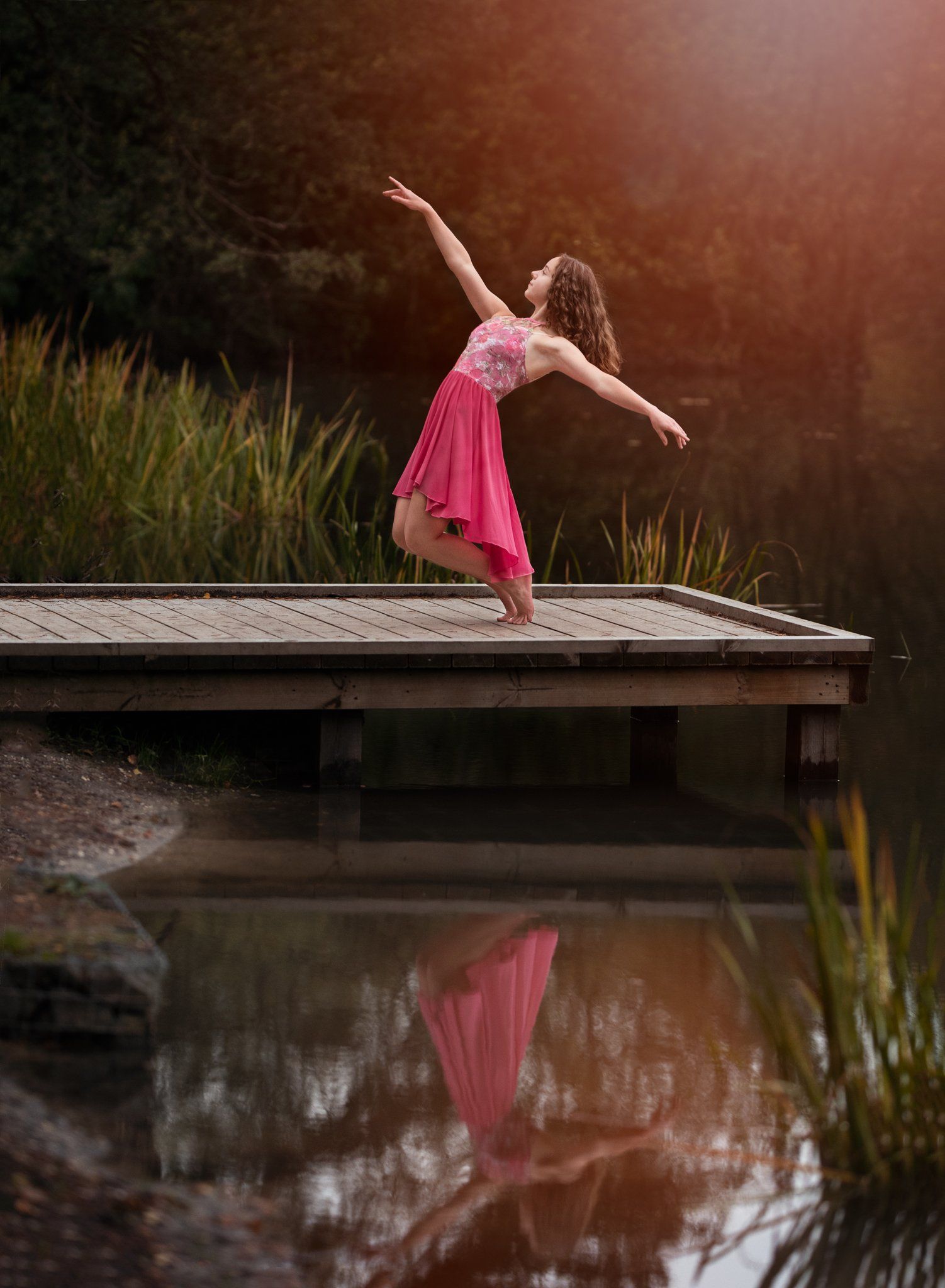 Dancer with reflection in the lake at sunset