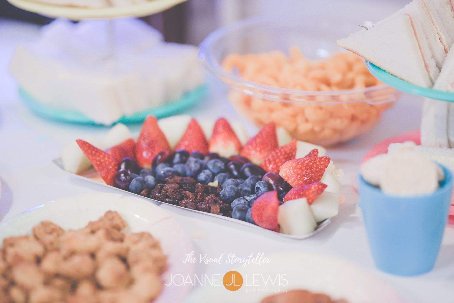 Rainbow fruit salad and party food at birthday party photographed in Harlow