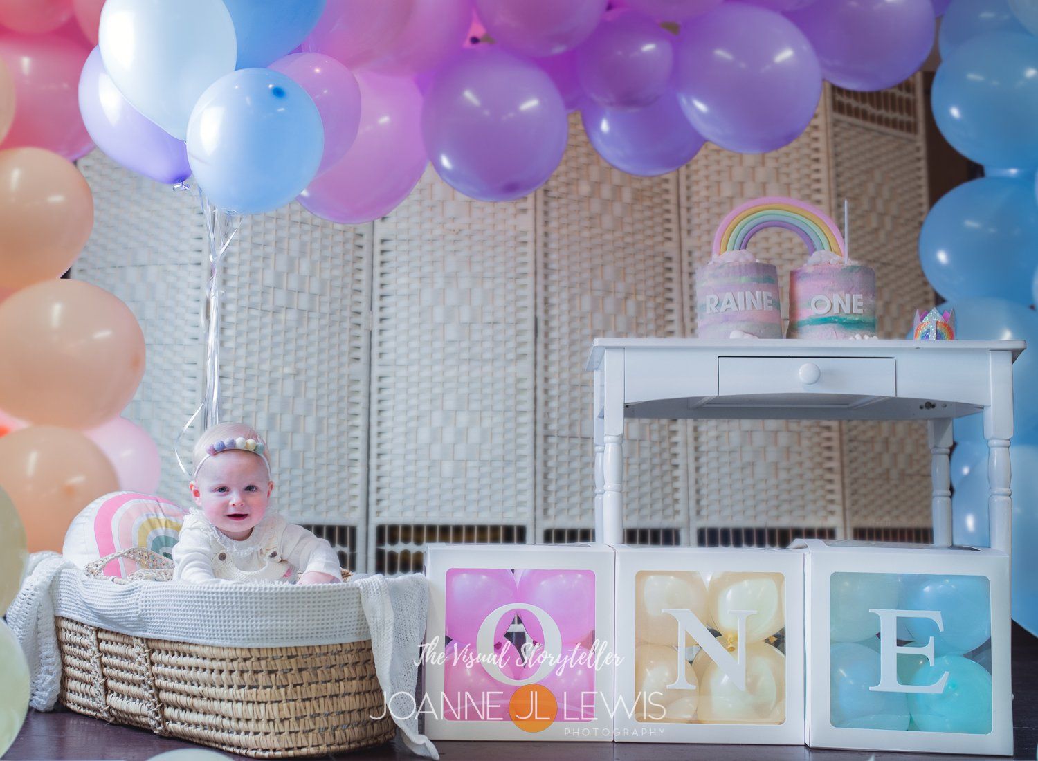 Birthday party photography in Harlow with pastel rainbow colours, a beautiful cake, and ONE boxes