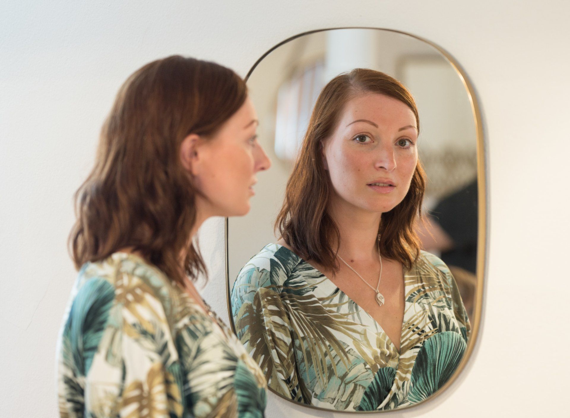 Georgina wearing her necklace with Gabriele's hand & footprint