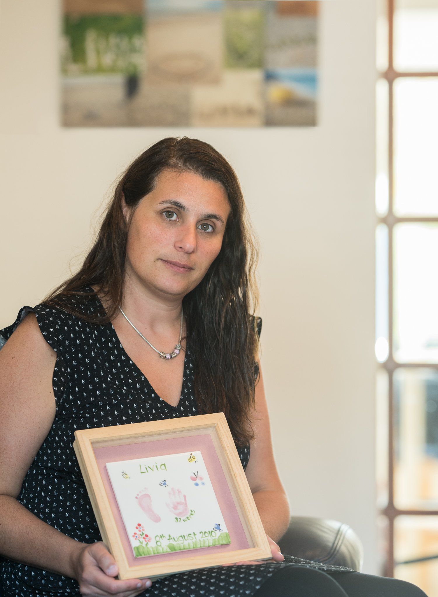 Gigliola Holding a ceramic of Livia's hand and footprint