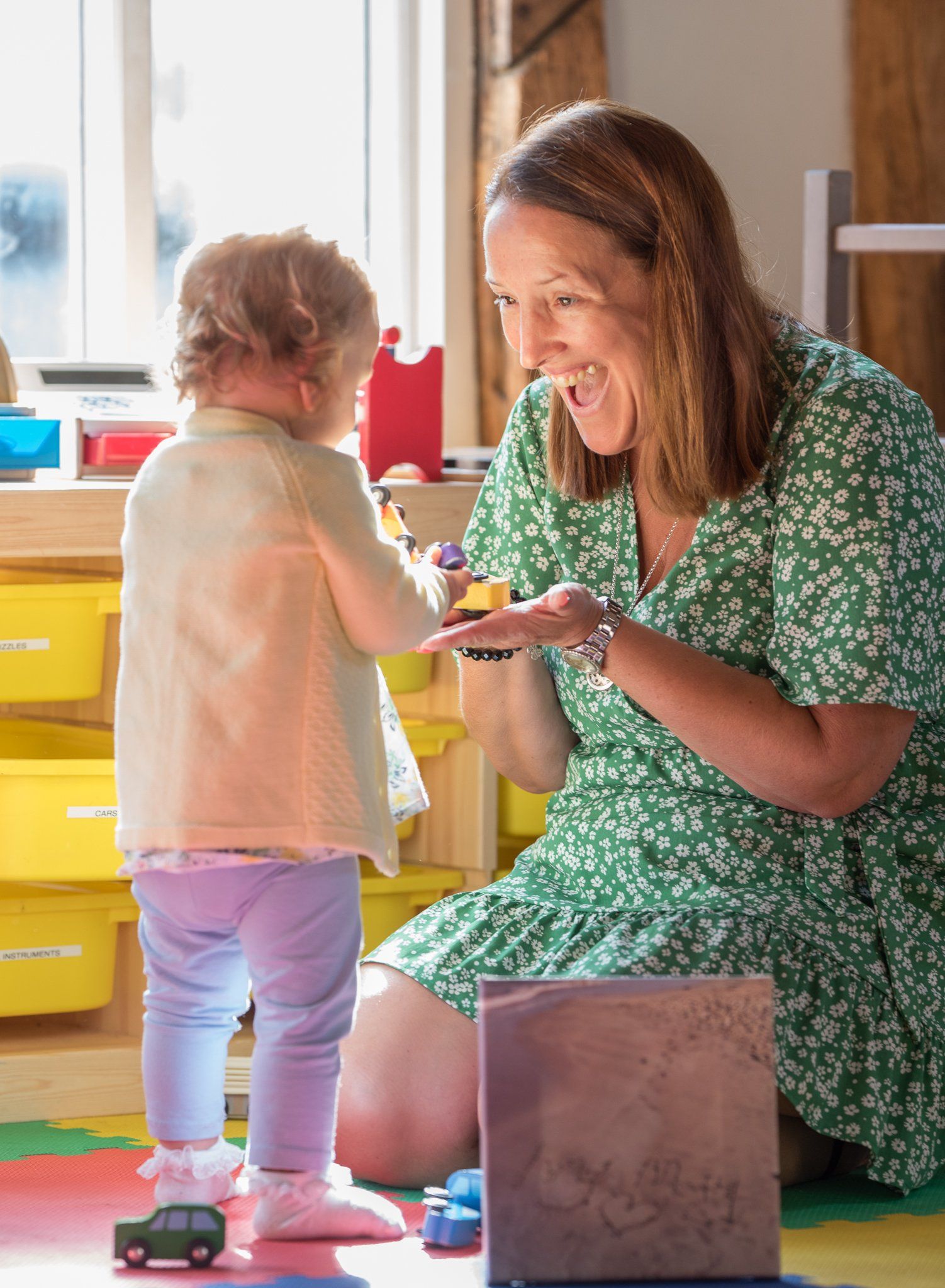 Smiling so happy playing with her rainbow daughter