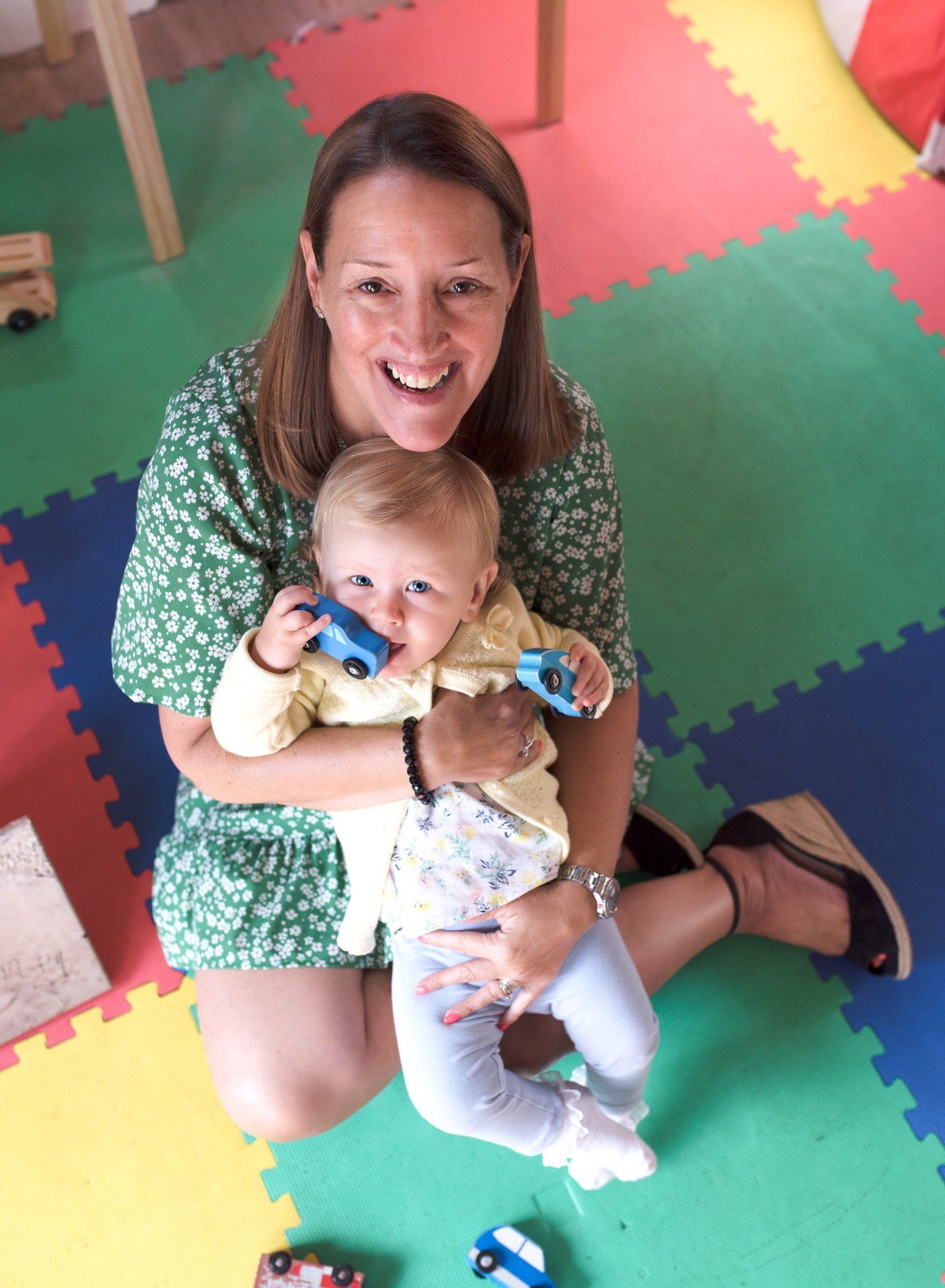 Birdseye view of smiling mother and daughter playing