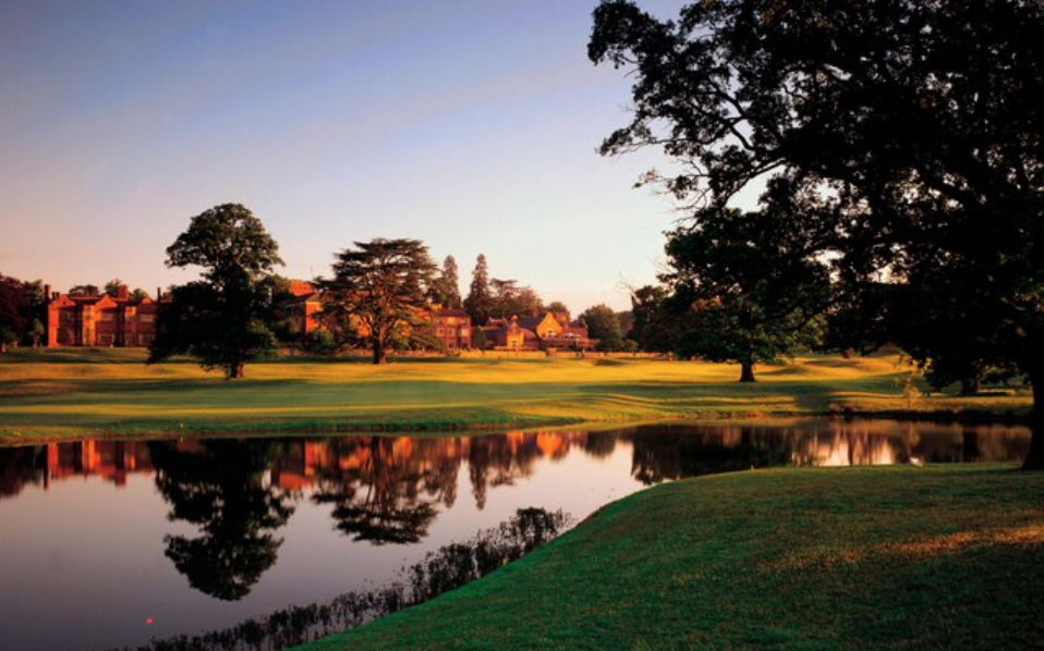 Hanbury Manor at sunset reflection in the lake and beautiful grounds in Ware