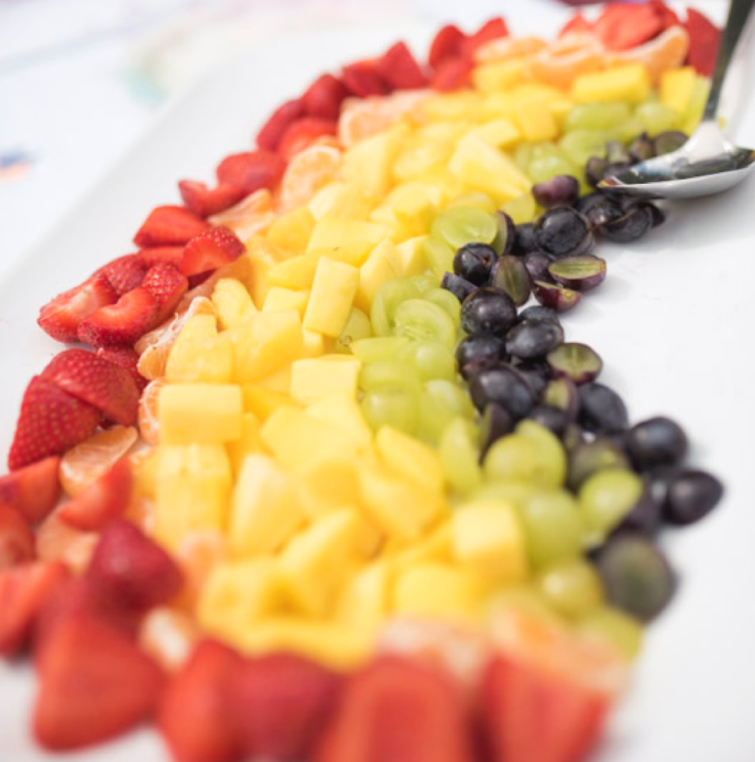 Eating healthy - A beautiful fruit salad shaped like a rainbow - making eating fun