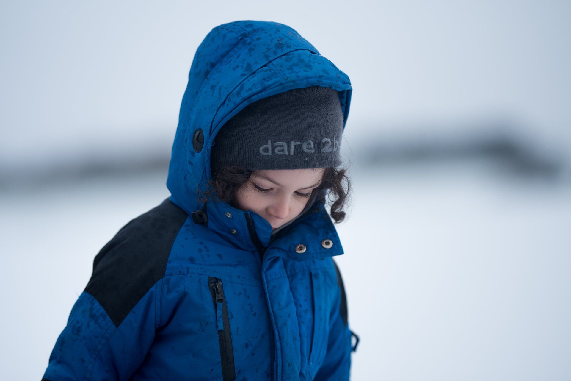 Boy wrapped up in the snow