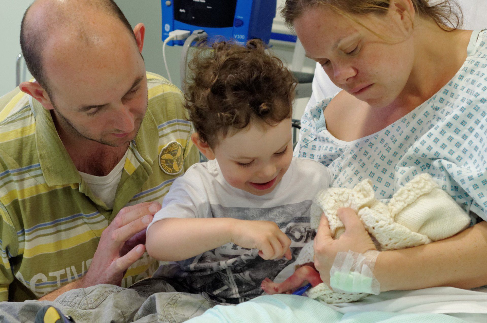 In the Hospital when Zachary met his baby brother - He was in awe of his tiny legs and feet