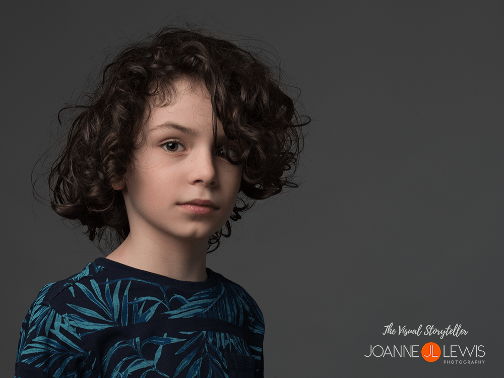 Beautiful boy with dark curly hair and brown eyes in Hertford Studio Photoshoot