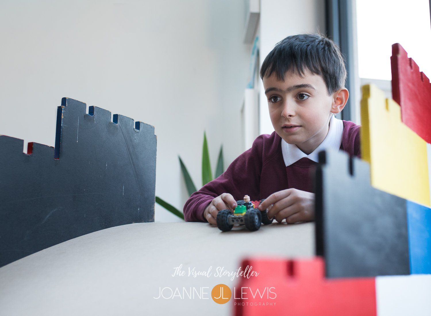 child sending lego car down ramp at Master Builders party