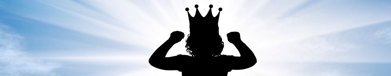A silhouette of a child wearing a crown.